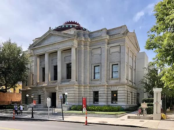 The columned stone facade of the Gibbes Museum of Art with a copper dome, on Meeting Street