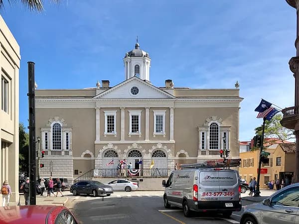 The pale Old Exchange Building with its cupola and arched ground-floor windows at the end of Broad Street