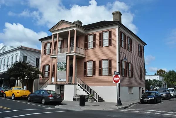 The pink two-story John Mark Verdier House with a double portico and dark shutters on a Beaufort street corner